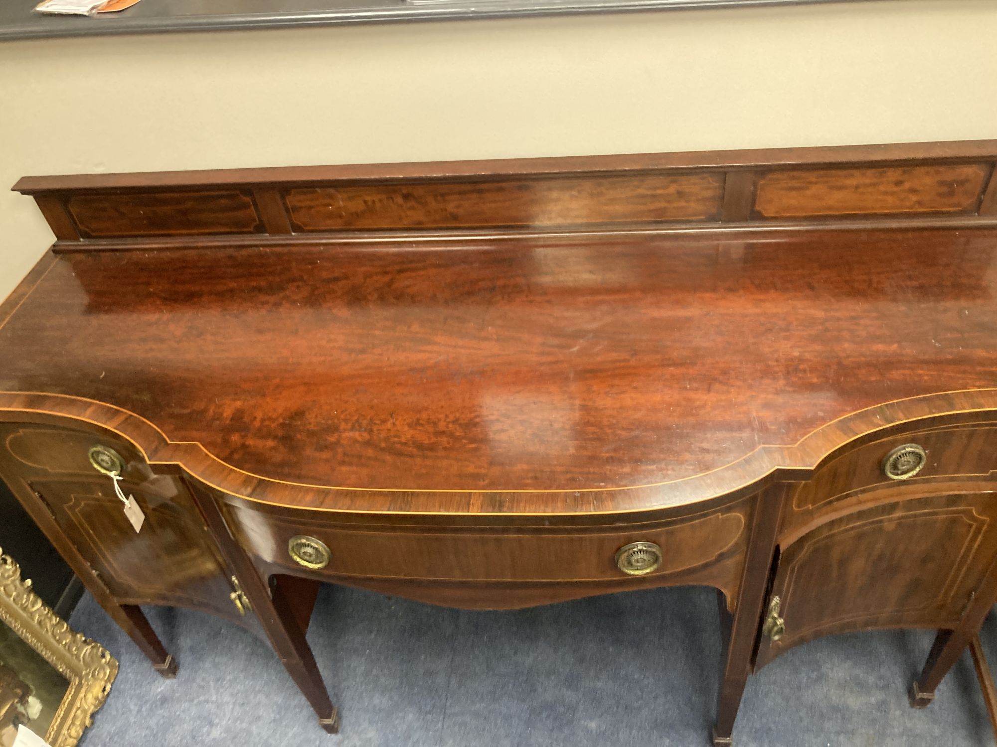 An Edwardian inlaid mahogany serpentine fronted sideboard, length 184cm, depth 68cm, height 112cm